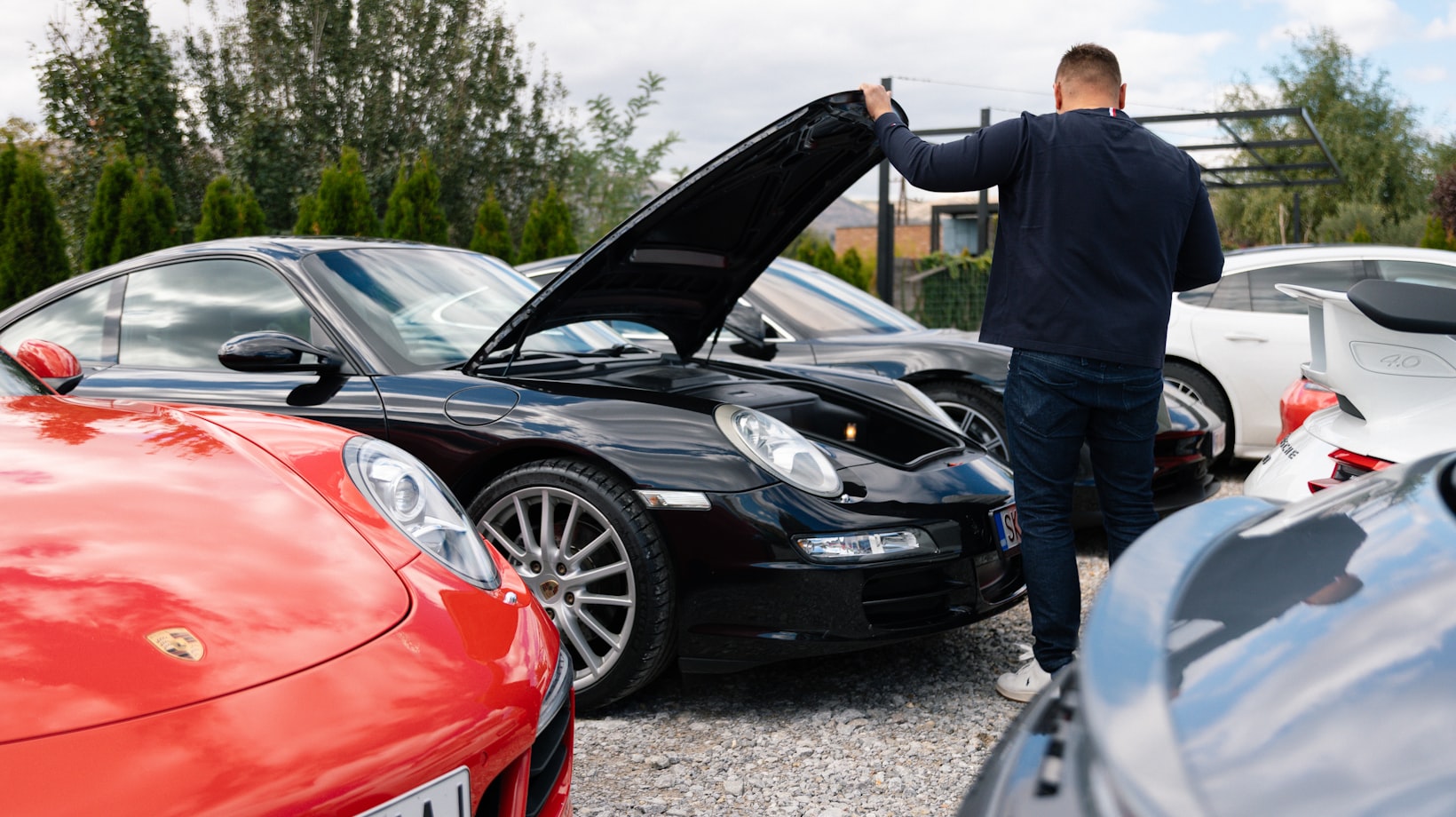 Used Porsche 911 with the hood raised being checked over before purchase